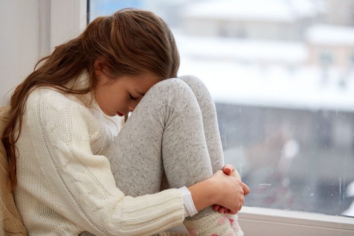 beautiful sad girl at home
